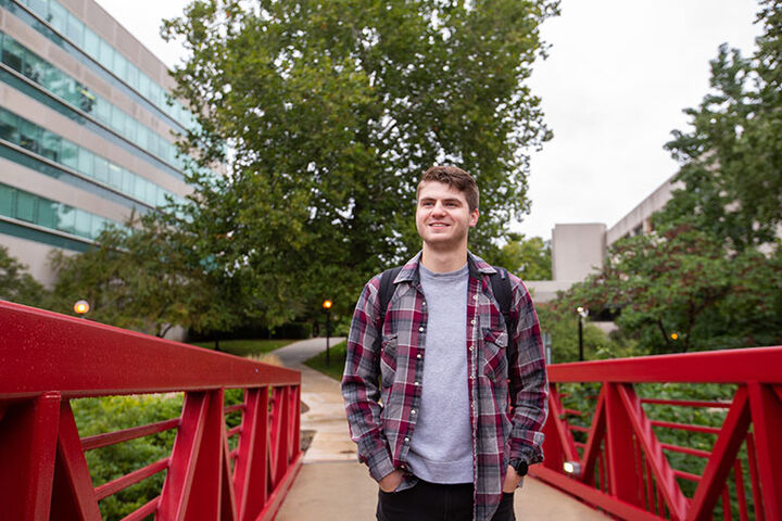 An IU South Bend student crossing the IU South Bend Pedestrian Bridge.